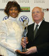 Former Soviet President Mikhail Gorbachev, right, and singer Whitney Houston pose with her award before the beginning of the World Women's Award ceremony in Hamburg's Congress Center, in northern Germany, Wednesday, June 9, 2004 Houston got the World Artist Award for Lifetime Achievement. The Women's World Awards are being presented of the first time this year to extraordinary women in 12 different categories. (AP Photo/Christof Stache, pool) 