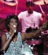 American pop singer Whitney Houston sings during a concert in the Olympic Sports Center in Beijing, capital of China, Sunday, July 25, 2004. The concert, part of Houston's China tour, drew more than 20,000 audience. (AP Photo/Xinhua, Wang Jianhua) 